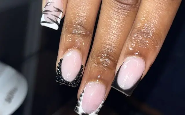 A medium length set by Jade, black french tips with lace and a bow
