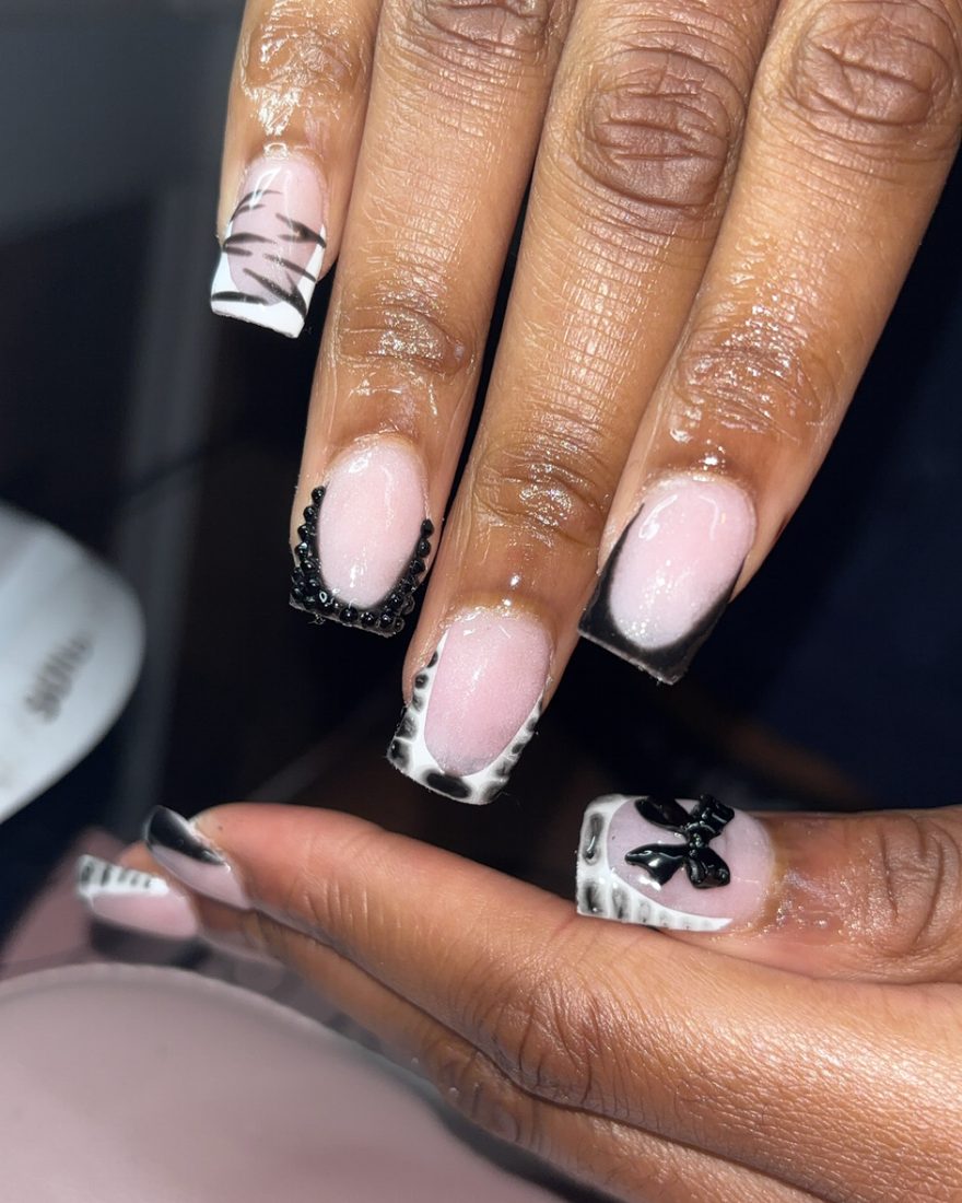 Long square set with black french tips, lace detail and a black bow